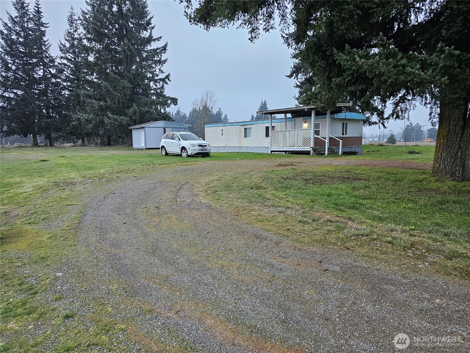 18525 Sargent Road Southwest Rochester, WA 98579 - Photo 36 of 37 a front view of a house with a yard and trees