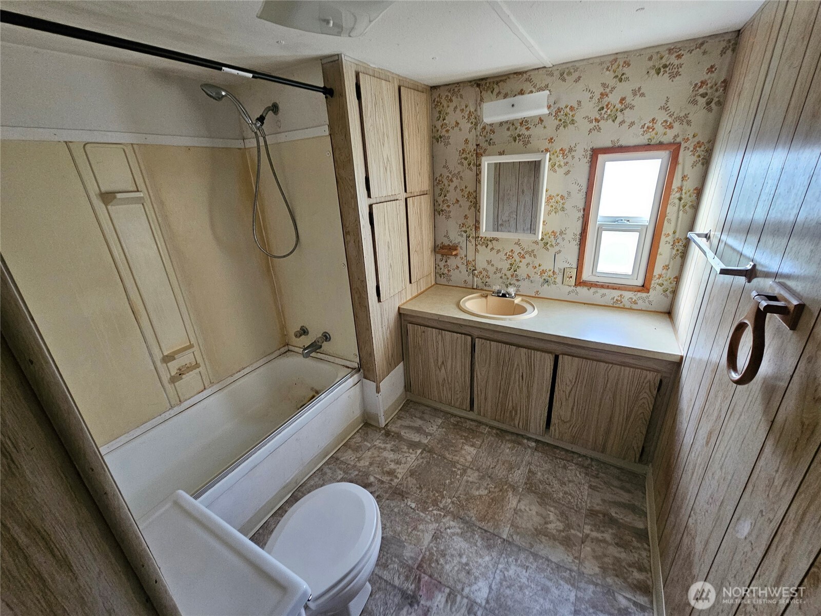 18525 Sargent Road Southwest Rochester, WA 98579 - Photo 7 of 37 a bathroom with a sink a toilet a mirror a vanity and a tub