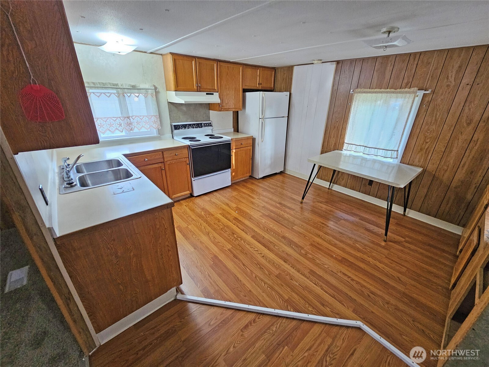 18525 Sargent Road Southwest Rochester, WA 98579 - Photo 9 of 37 a kitchen with wooden floor and a sink
