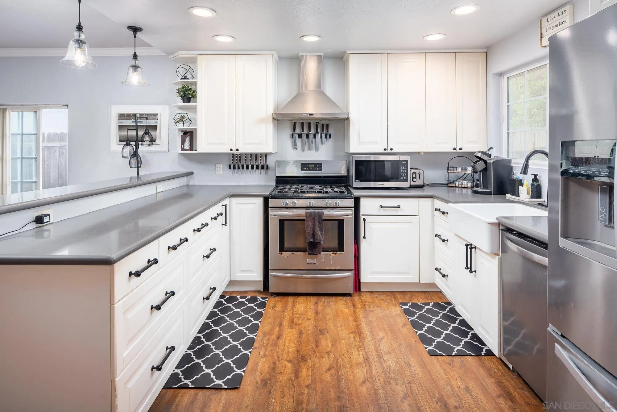 9357 Dempster Drive Santee, CA 92071 - Photo 13 of 35 a large white kitchen with stainless steel appliances granite countertop a stove and a sink