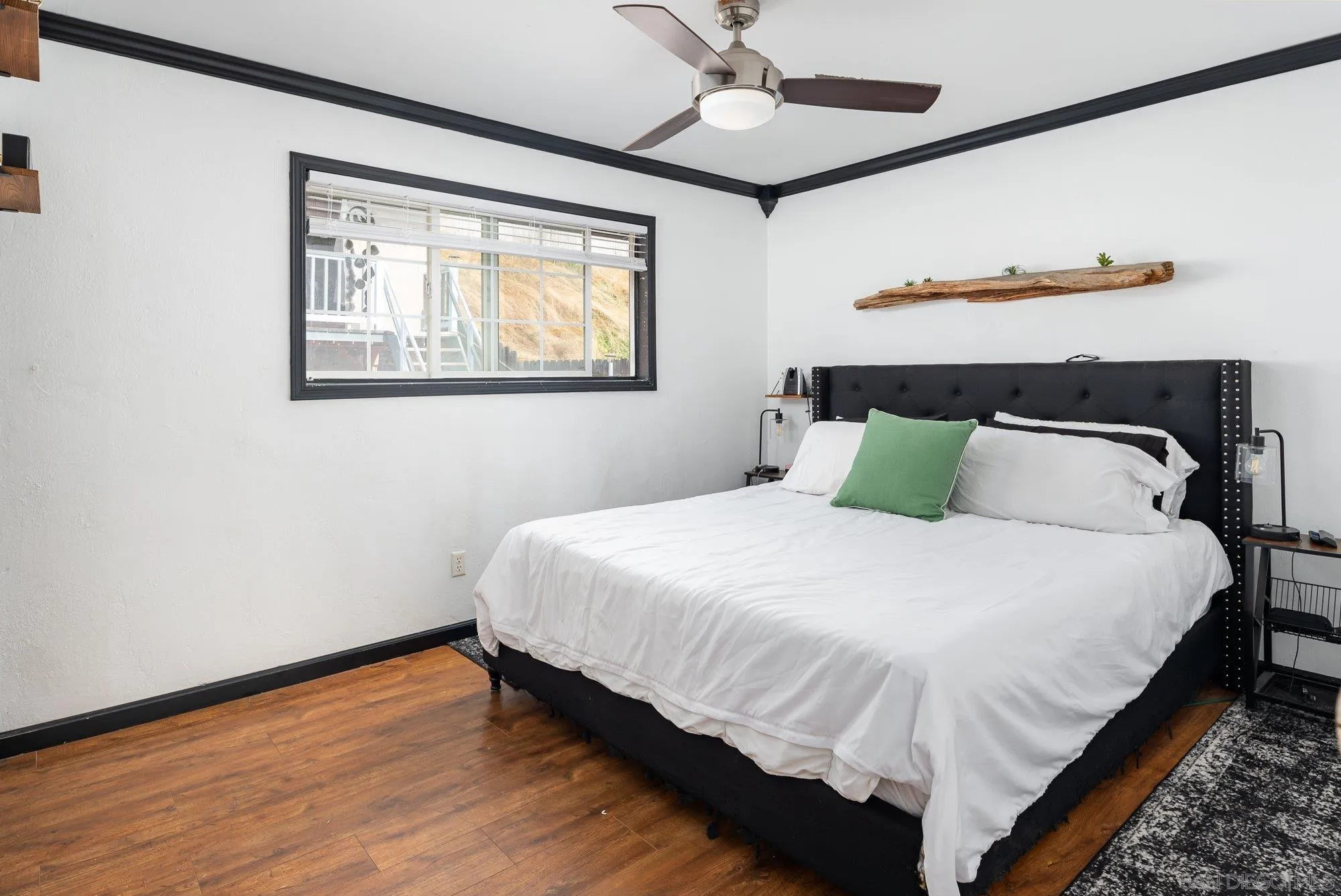 9357 Dempster Drive Santee, CA 92071 - Photo 20 of 35 a bedroom with a bed and wooden floor