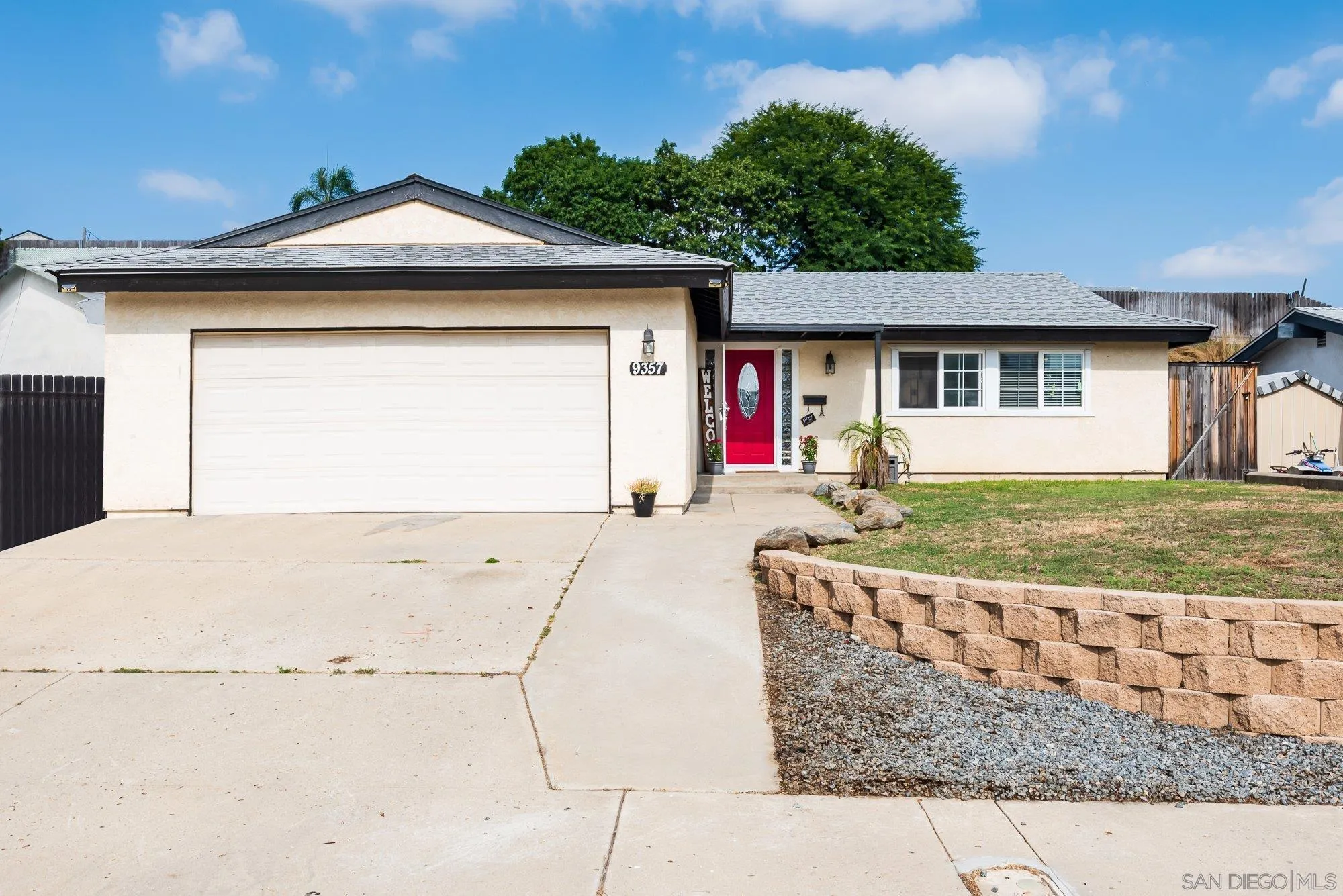 9357 Dempster Drive Santee, CA 92071 - Photo 5 of 35 a front view of a house with a yard and garage