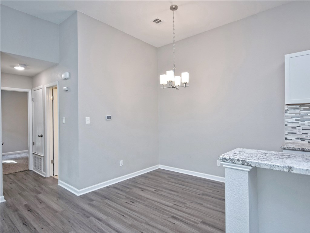2302 Fuzz Fairway, Unit B Austin, TX 78728 - Photo 13 of 27 Dining room with breakfast bar that opens into kitchen.