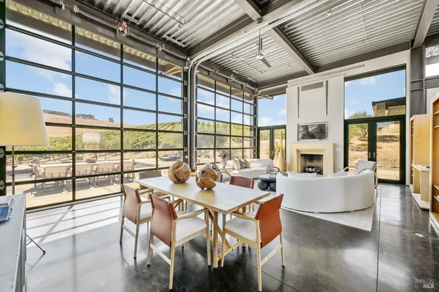 a large bedroom with a bed and glass door