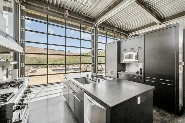 a spacious bedroom with a bed and a large window