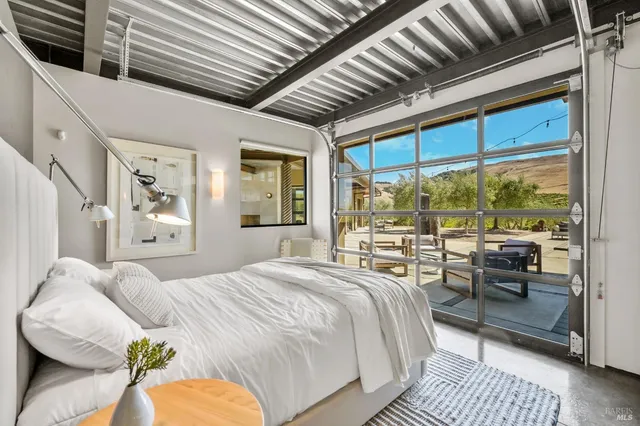 a bedroom with a large bed and a large window