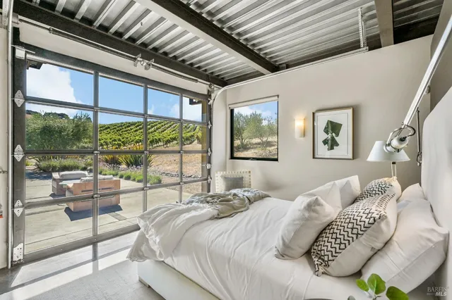 a bedroom with two beds and a large window