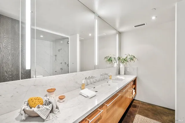 a bedroom with a large bed and a large window with the outer view