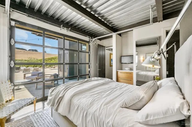 a living room filled with furniture and a potted plant