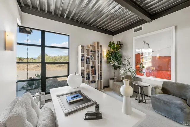 a view of a swimming pool and outside seating