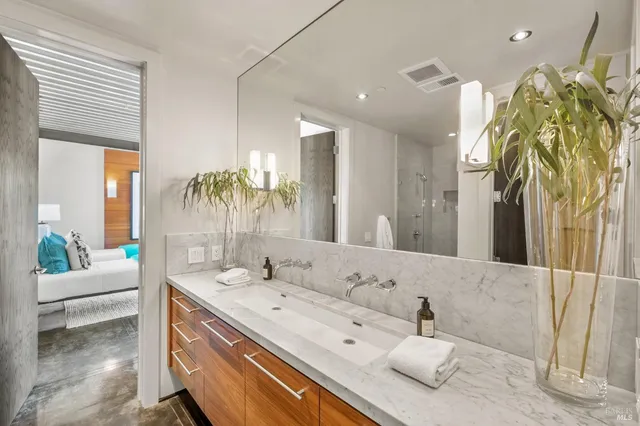 a bedroom with furniture and a large window