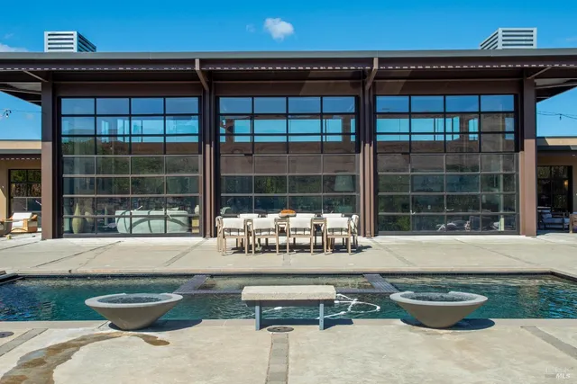 a kitchen with stainless steel appliances granite countertop a sink a stove and a wooden floors