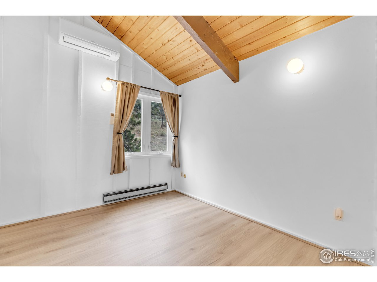 287 Brook Circle Boulder, CO 80302 - Photo 20 of 36 an empty room with wooden floor and windows
