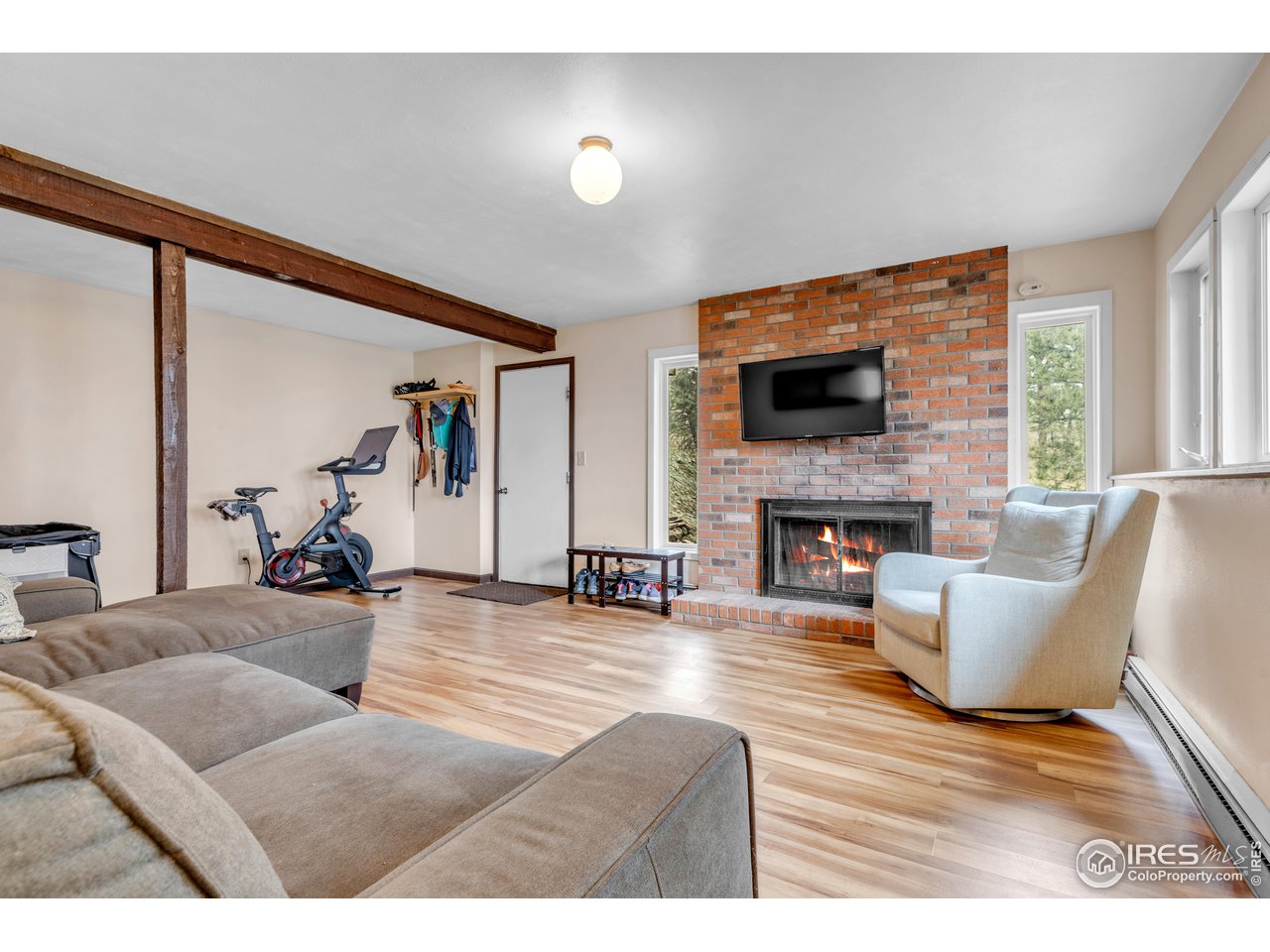 287 Brook Circle Boulder, CO 80302 - Photo 25 of 36 a living room with furniture a flat screen tv and a fireplace