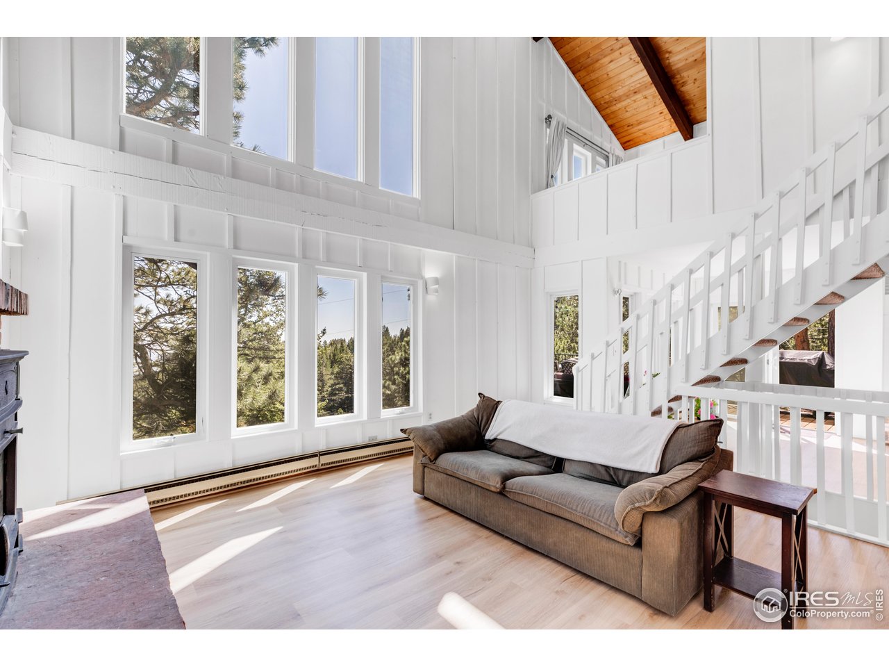 287 Brook Circle Boulder, CO 80302 - Photo 3 of 36 a living room with furniture a rug and a floor to ceiling window
