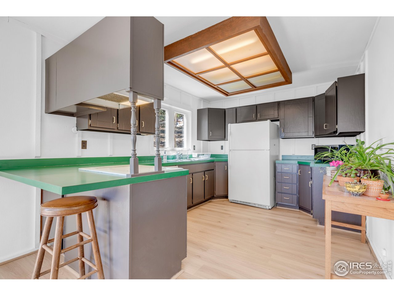 287 Brook Circle Boulder, CO 80302 - Photo 6 of 36 a kitchen with a refrigerator and a table