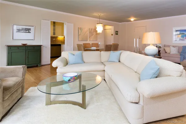 a living room with furniture a rug and a lamp