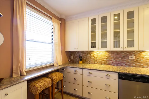 a bathroom with a granite countertop sink and a bathtub