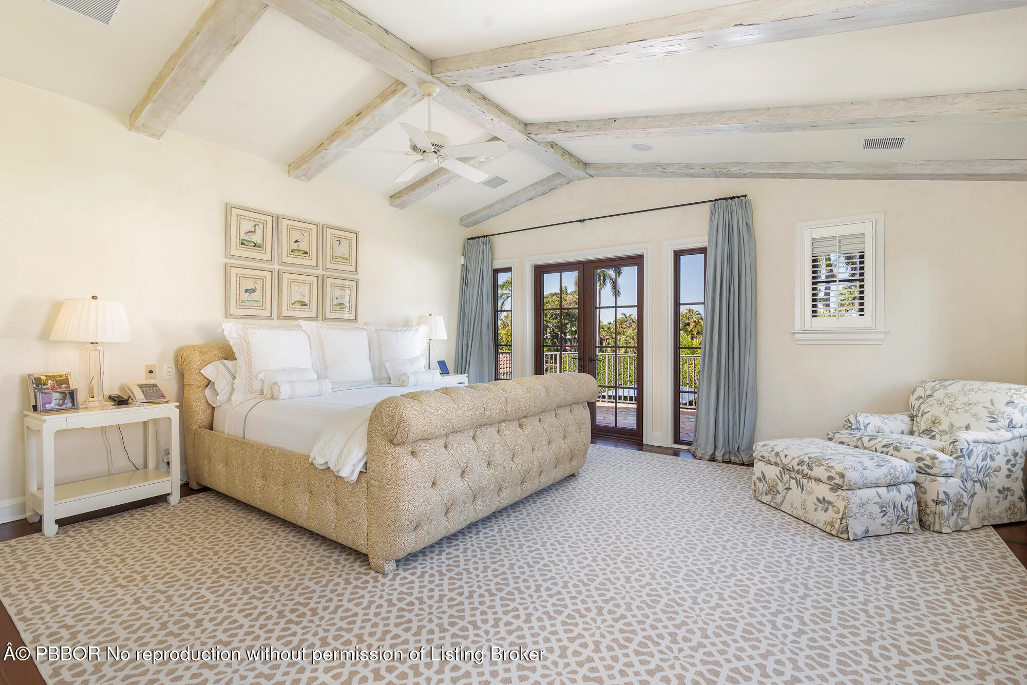 237 El Bravo Way Palm Beach, FL 33480 - Photo 18 of 41 a spacious bedroom with a bed and a chandelier