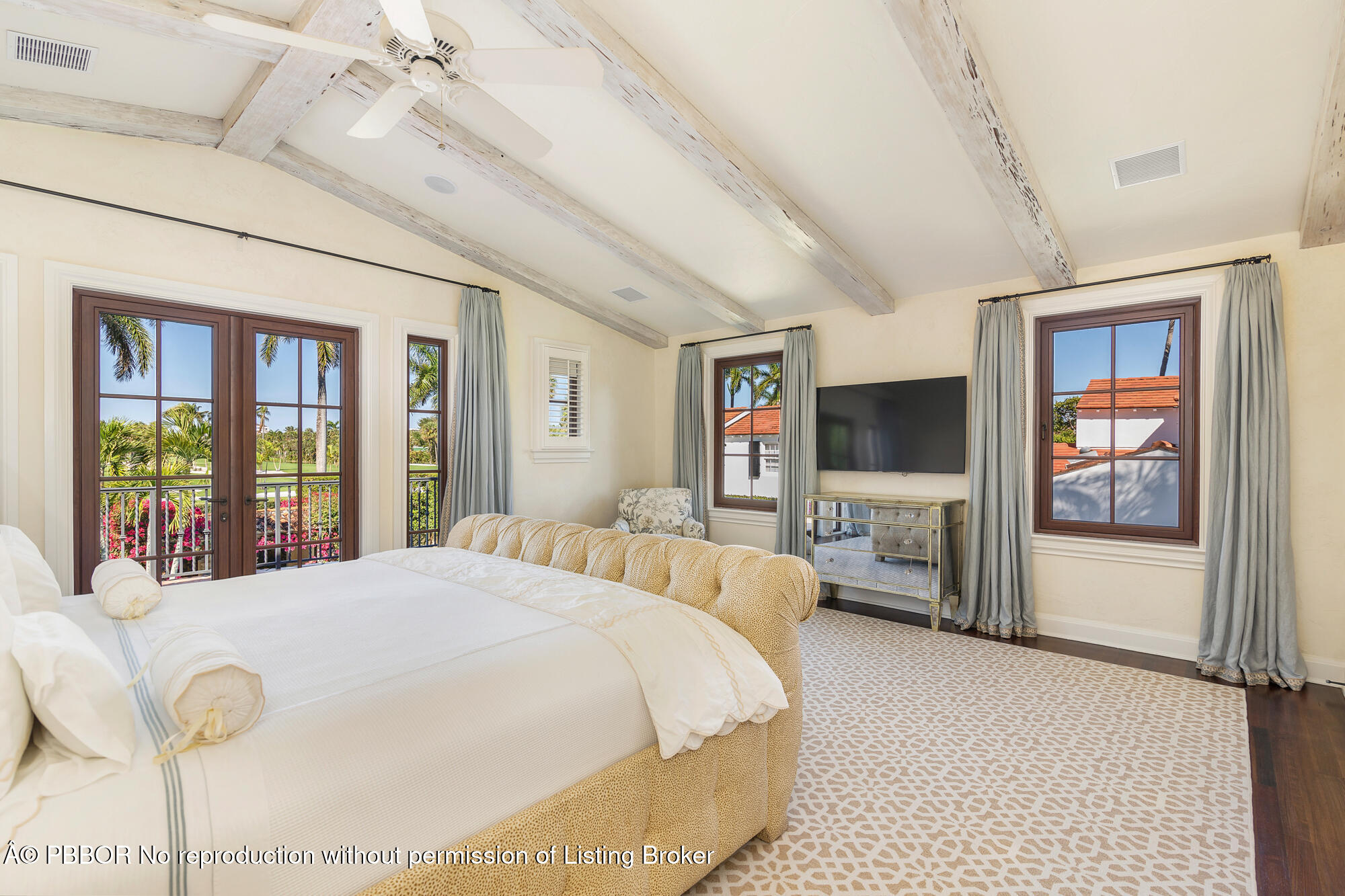 237 El Bravo Way Palm Beach, FL 33480 - Photo 19 of 41 a bedroom with a large bed and a flat tv screen