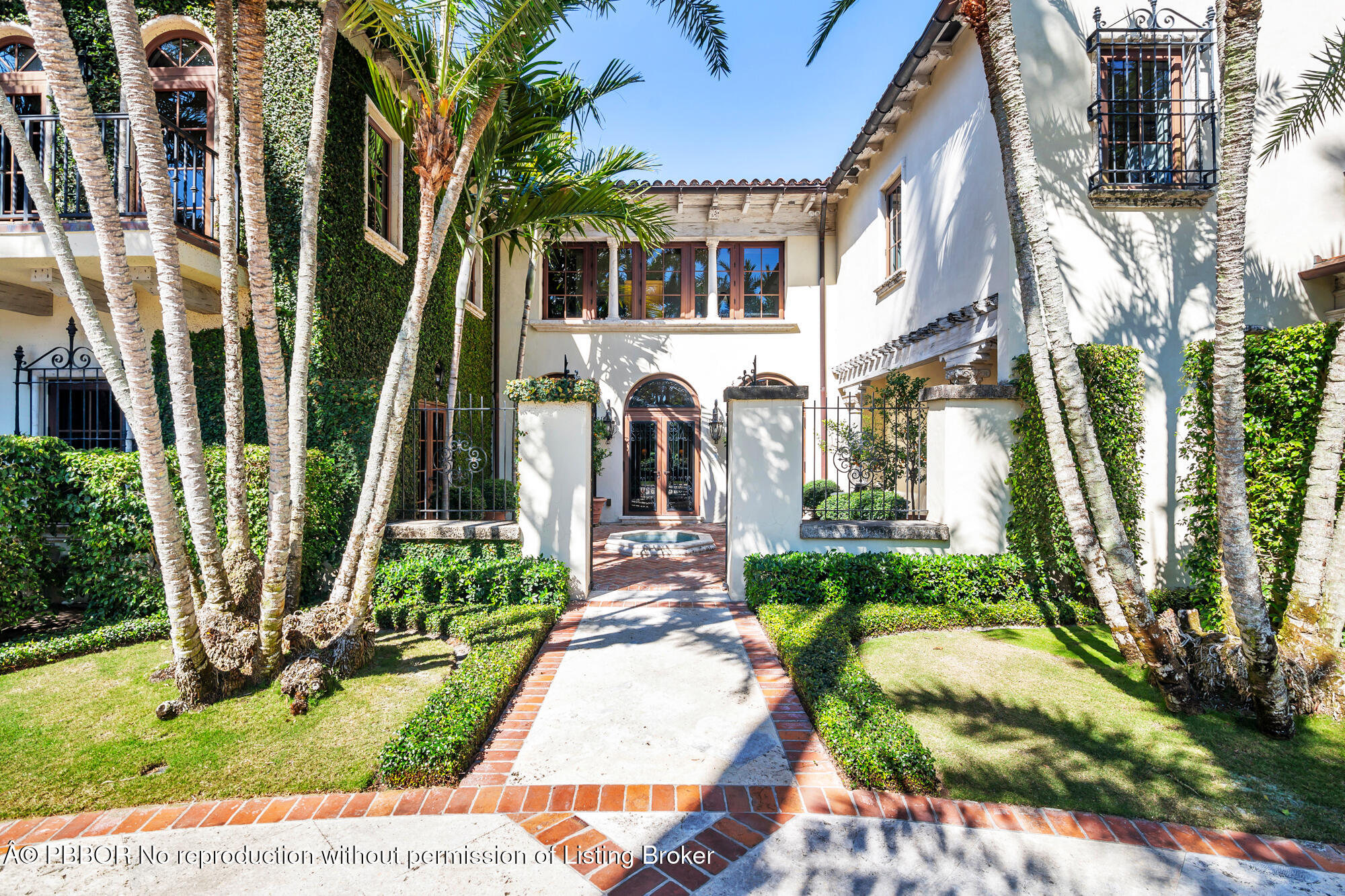 237 El Bravo Way Palm Beach, FL 33480 - Photo 3 of 41 a front view of a house with a garden