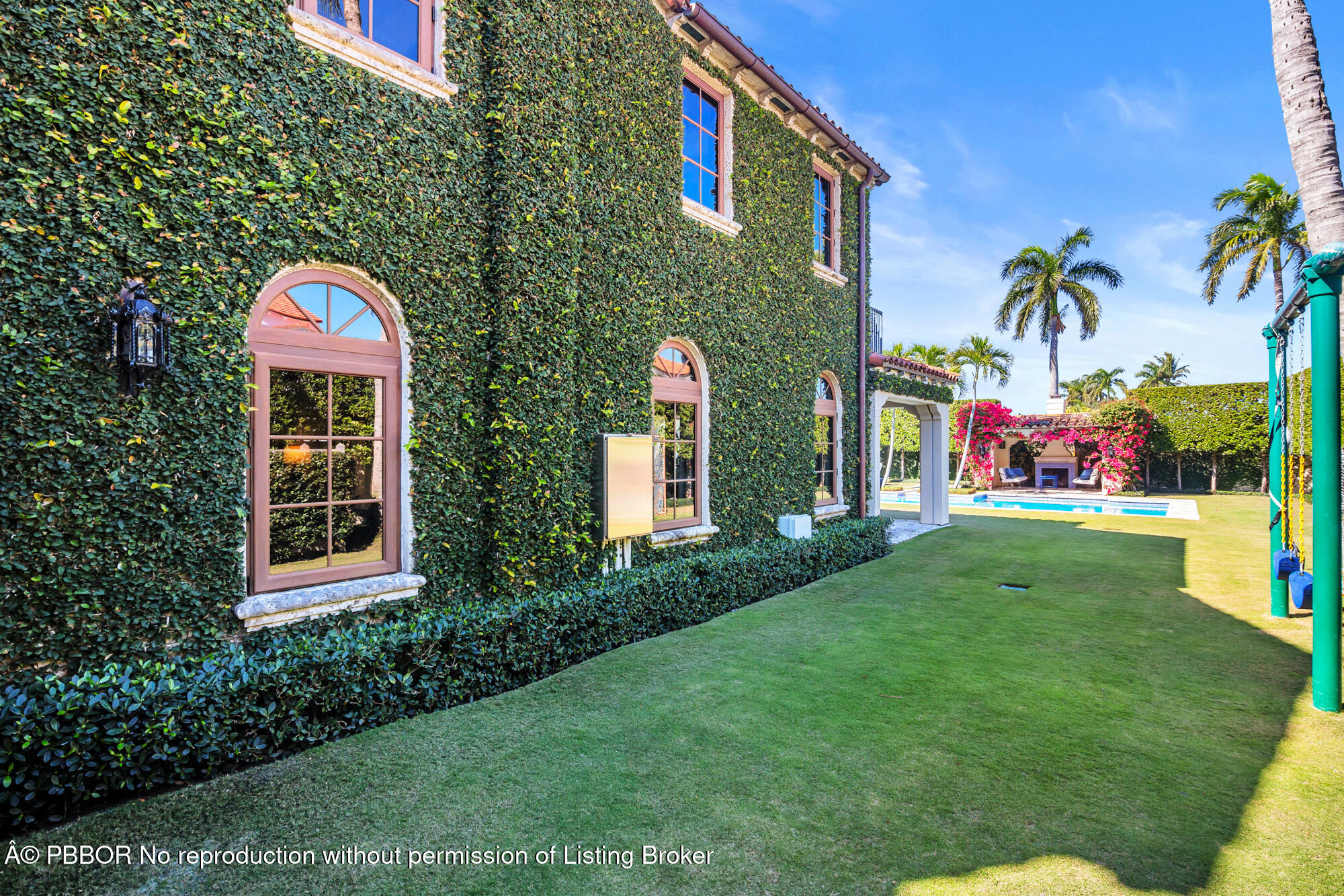 237 El Bravo Way Palm Beach, FL 33480 - Photo 32 of 41 a front view of a multi story residential apartment building with a yard