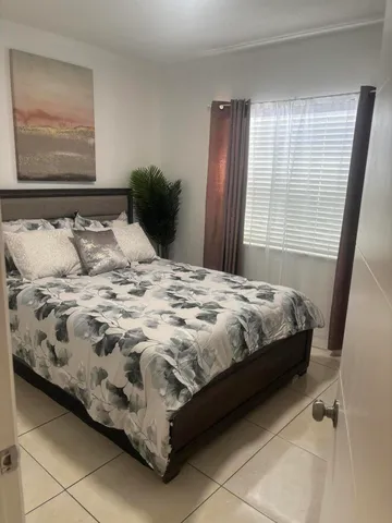 a bed sitting in a bedroom next to a window