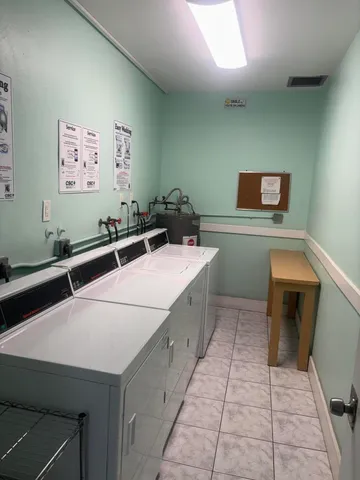 a room with a table chairs and a stove top oven