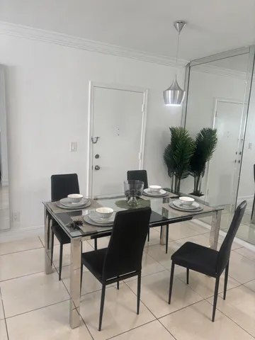 a view of a workspace with a table and chairs in a room
