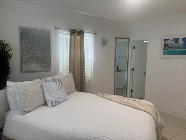 a bedroom with a large bed and a chandelier