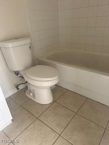 5220-5222 27th Street Southwest Lehigh Acres, FL 33973 - Photo 8 of 9 a white toilet sitting next to a bath tub