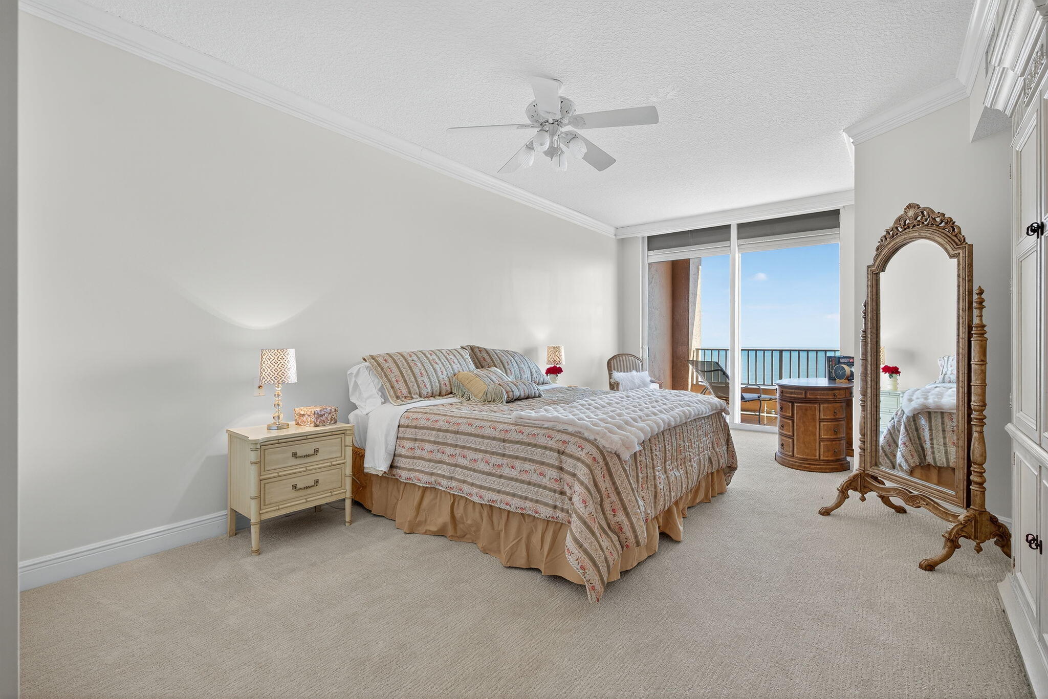 700 Ocean Royale, Unit PH 3 Juno Beach, FL 33408 - Photo 11 of 38 a spacious bedroom with a bed and a chandelier