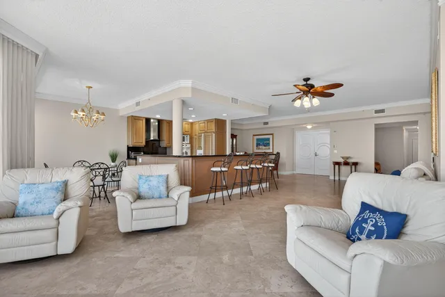 a living room with furniture and kitchen view