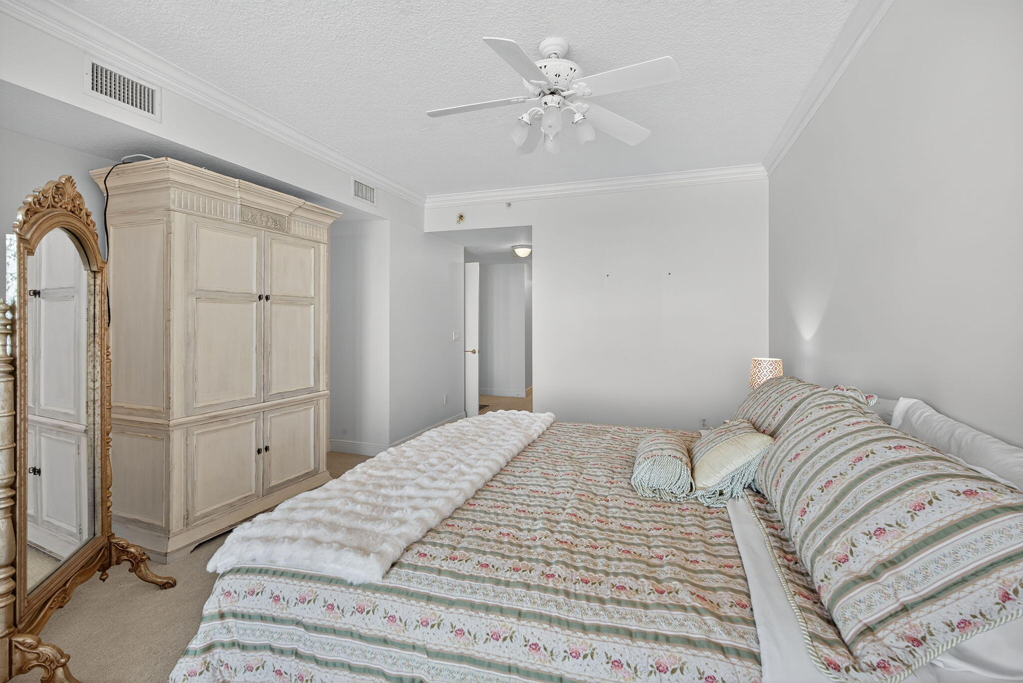 700 Ocean Royale, Unit PH 3 Juno Beach, FL 33408 - Photo 20 of 38 a bedroom with a large bed and a chandelier