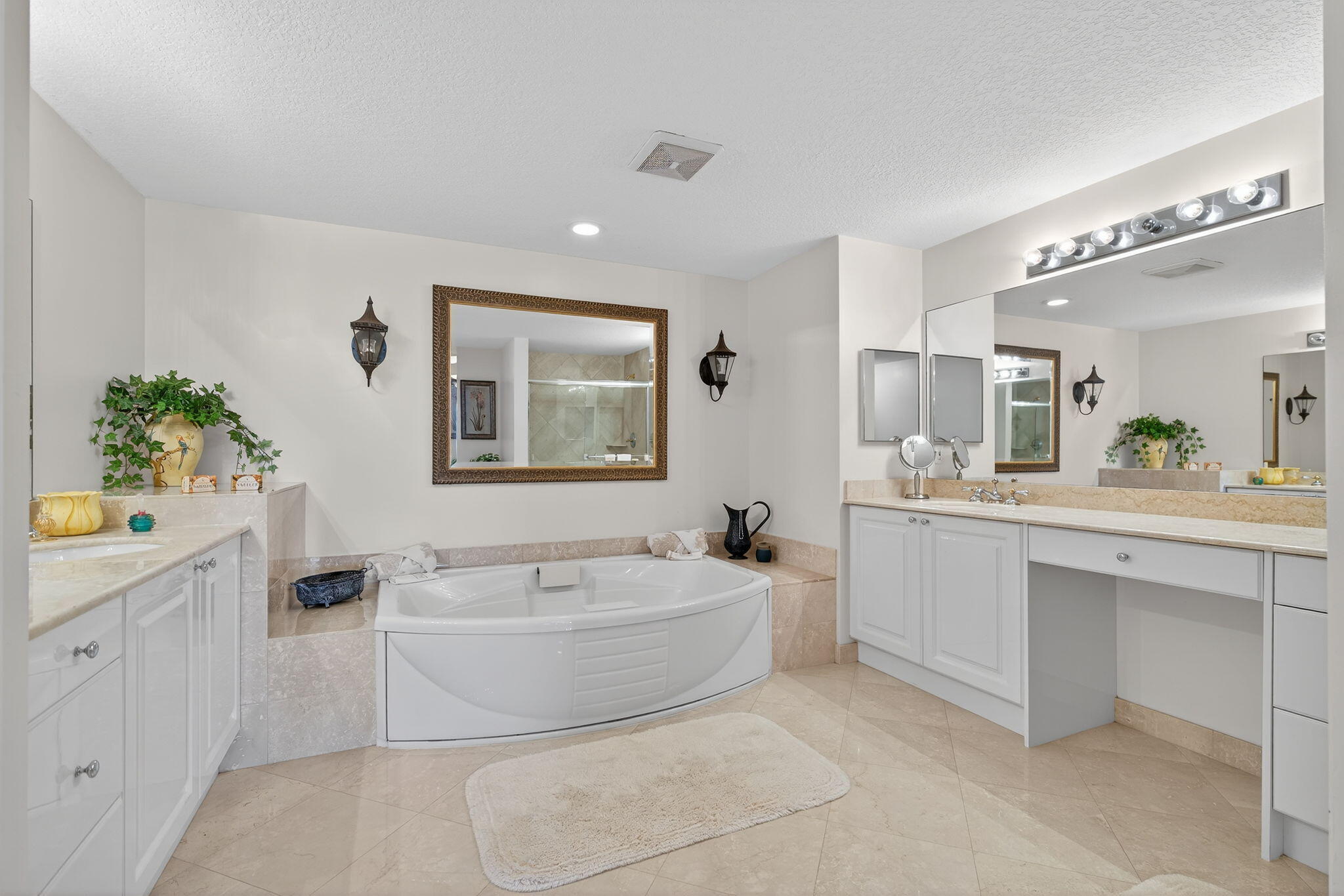 700 Ocean Royale, Unit PH 3 Juno Beach, FL 33408 - Photo 24 of 38 a spacious bathroom with a bathtub a sink and a mirror