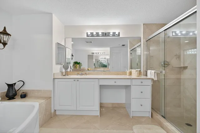 a spacious bathroom with a sink double vanity and a mirror