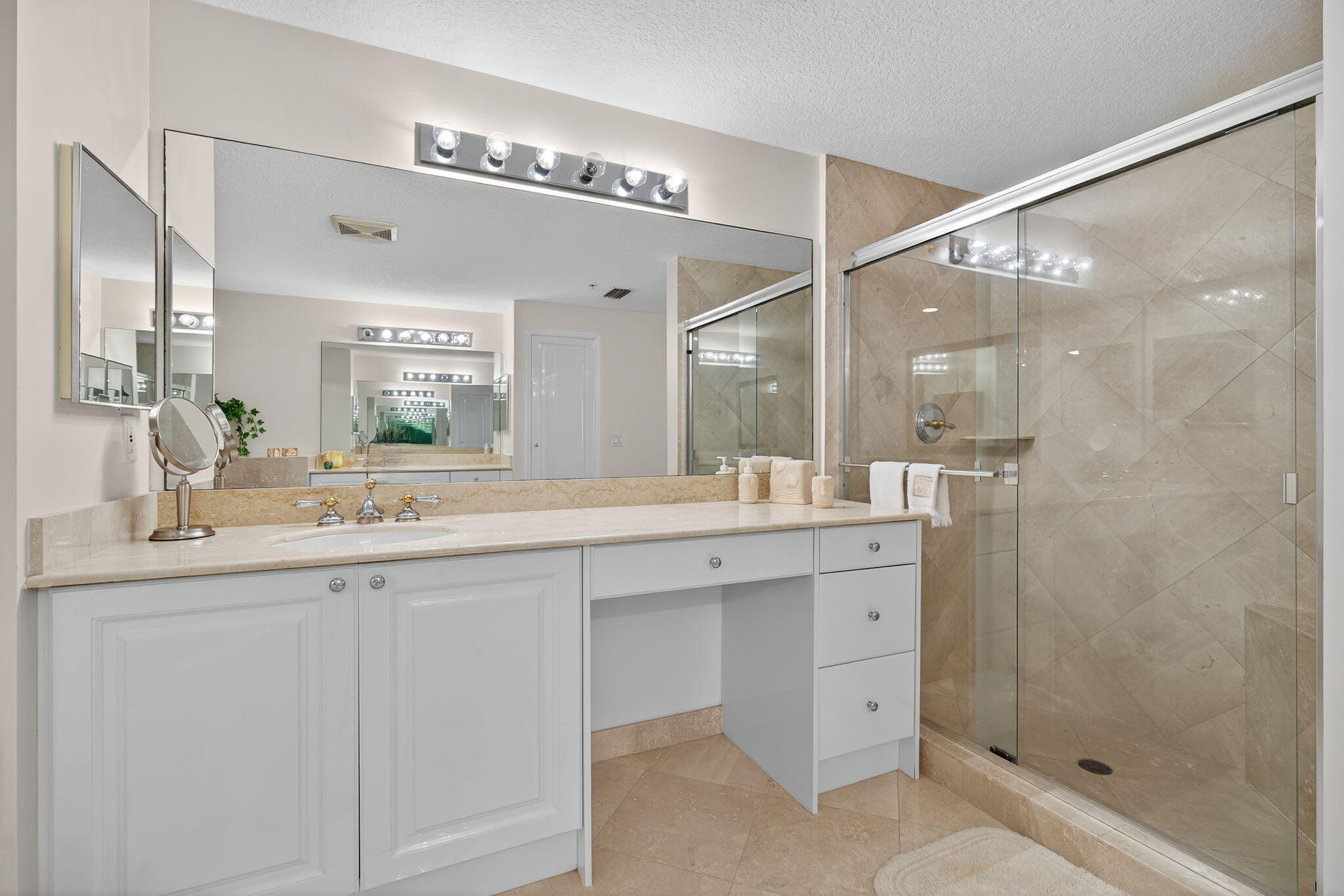 700 Ocean Royale, Unit PH 3 Juno Beach, FL 33408 - Photo 26 of 38 a bathroom with a shower sink and mirror