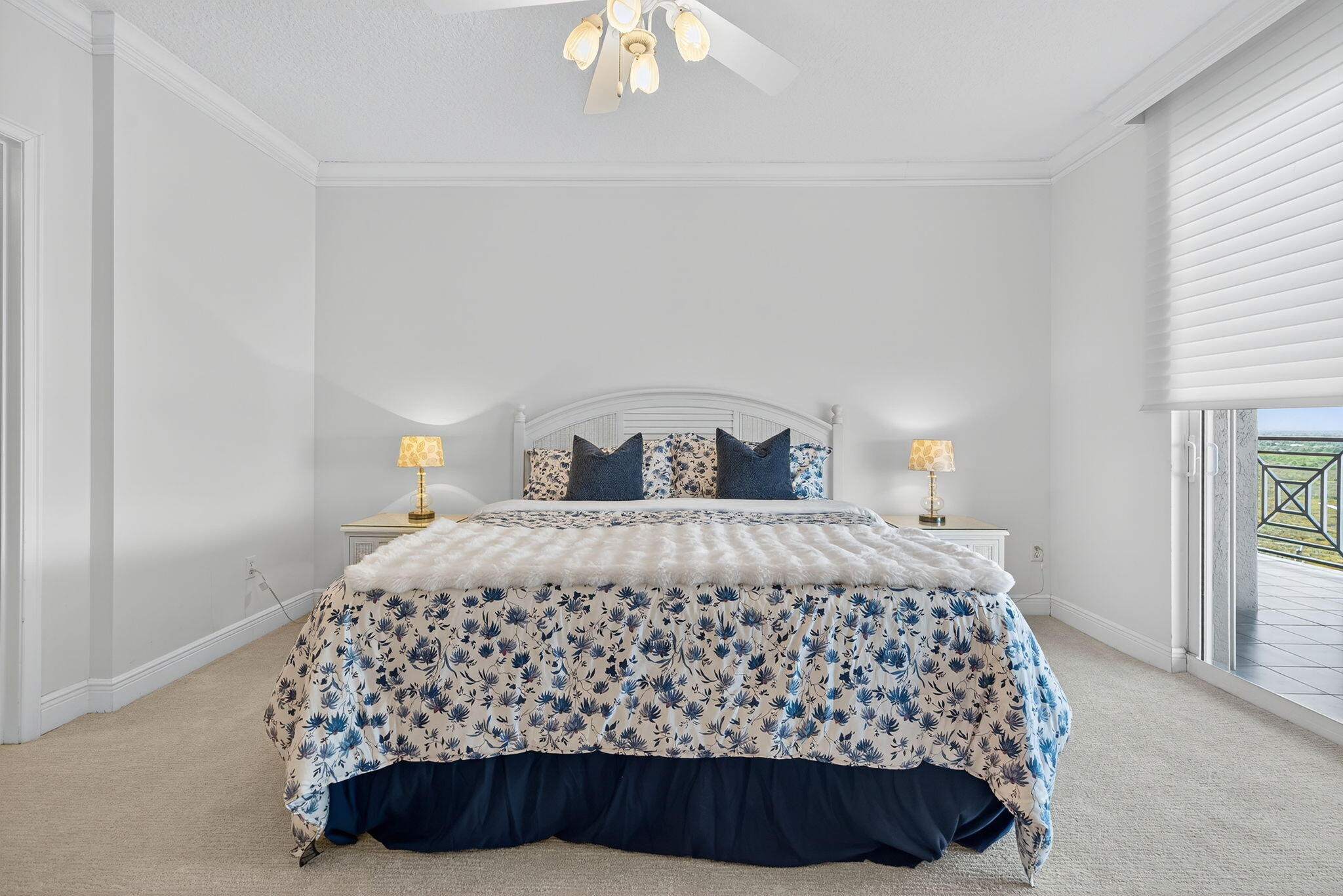 700 Ocean Royale, Unit PH 3 Juno Beach, FL 33408 - Photo 32 of 38 a bedroom with a bed and a chandelier