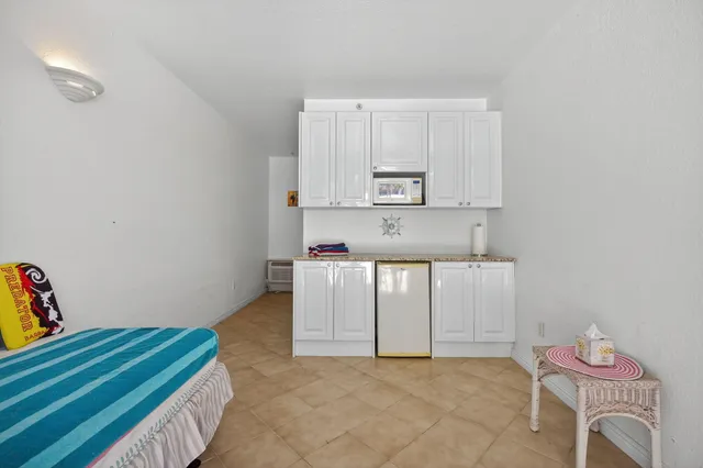 a kitchen with cabinets and a wooden floor