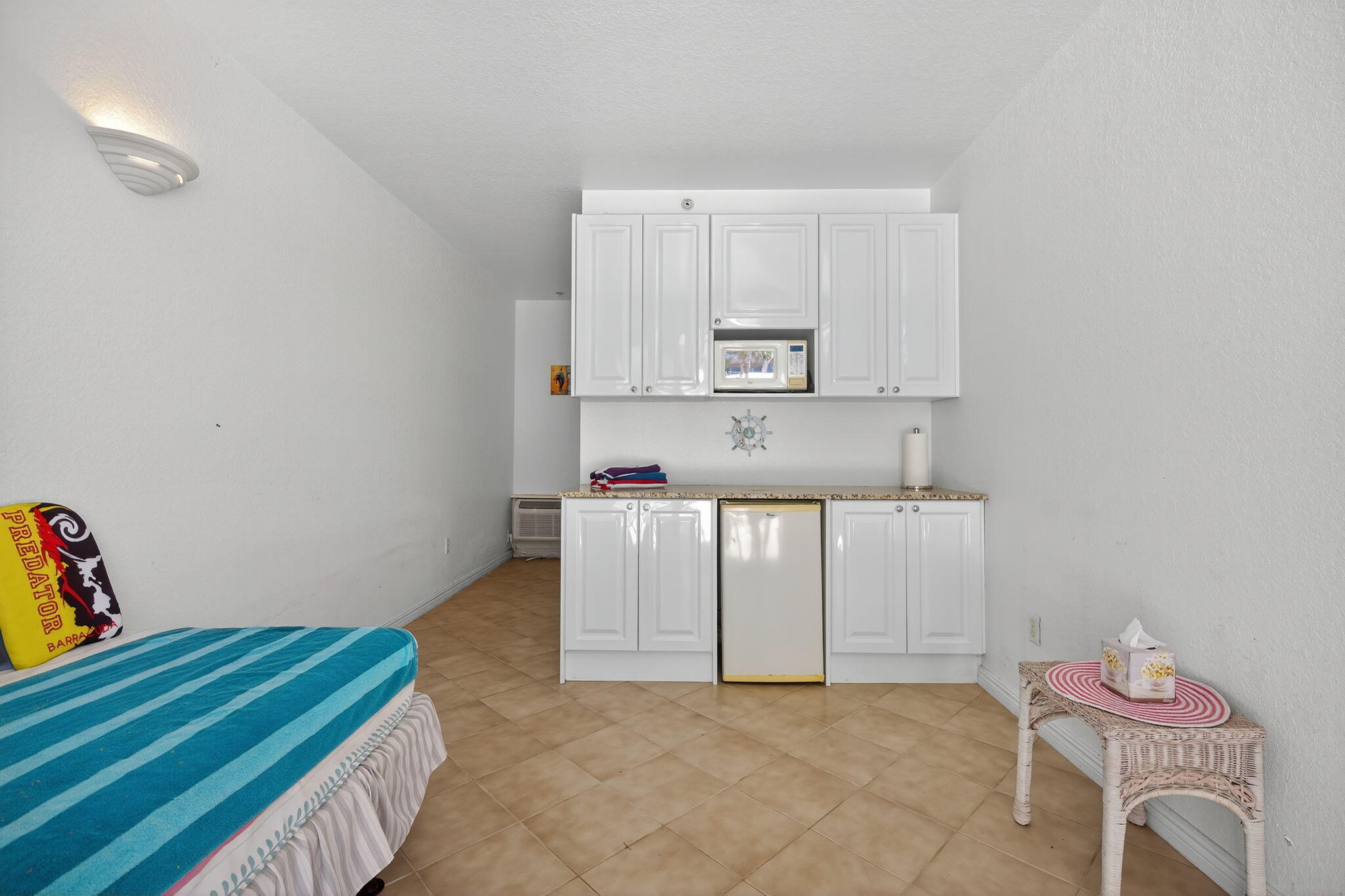 700 Ocean Royale, Unit PH 3 Juno Beach, FL 33408 - Photo 35 of 38 a kitchen with cabinets and a wooden floor