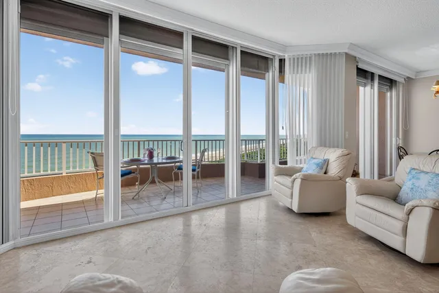 a living room with furniture and a floor to ceiling window