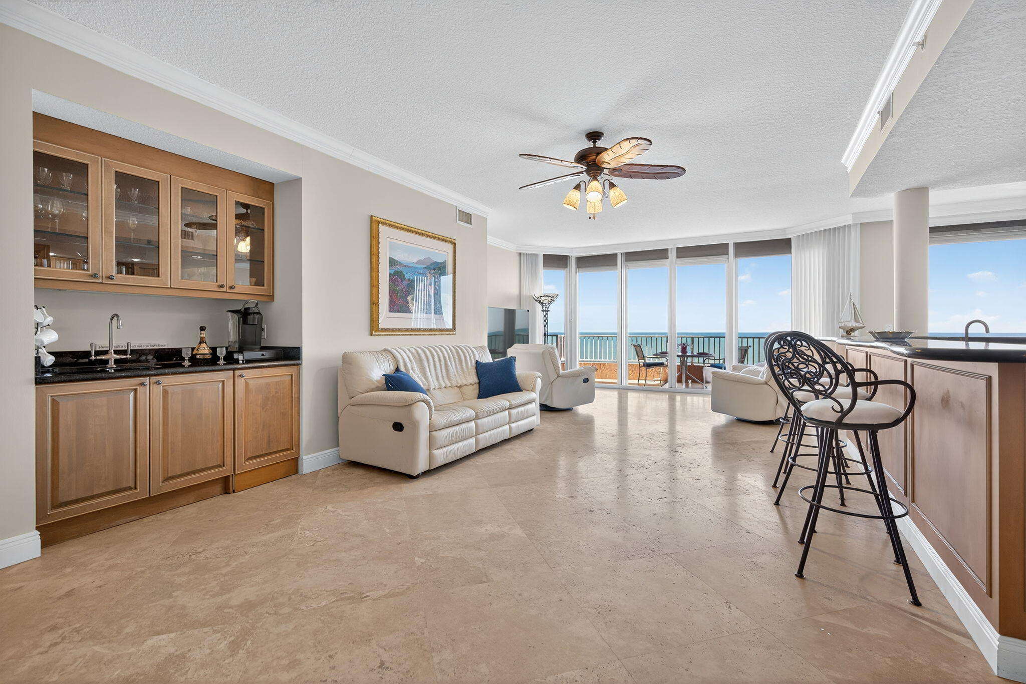 700 Ocean Royale, Unit PH 3 Juno Beach, FL 33408 - Photo 7 of 38 a living room with furniture and a kitchen