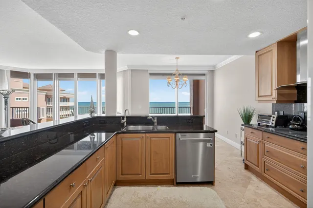 a kitchen with granite countertop a sink and a stove