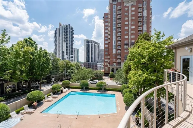 a view of a balcony with chairs and potted plants