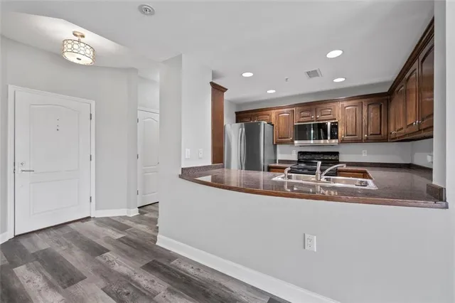 a kitchen with kitchen island granite countertop a sink window and cabinets