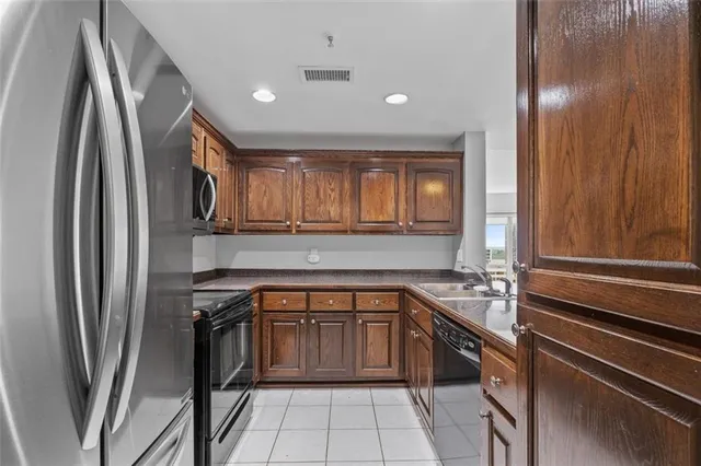 a kitchen with a sink appliances and cabinets