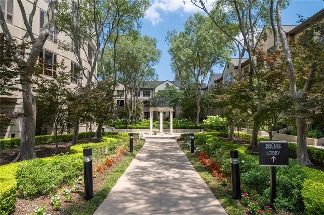 a front view of a house with a yard and fountain