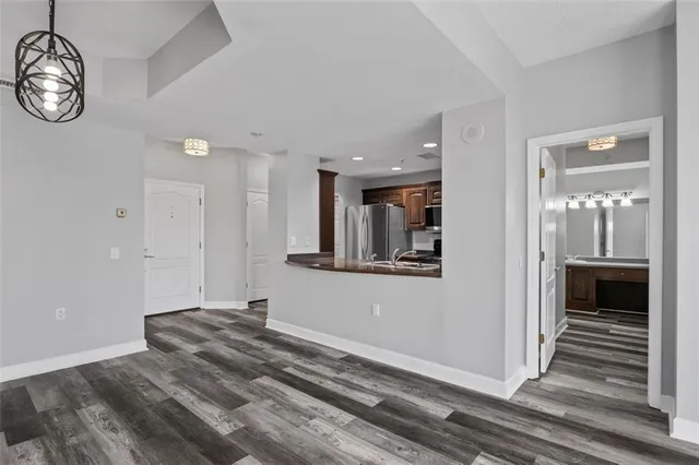 a view of a hallway with wooden floor and a front door