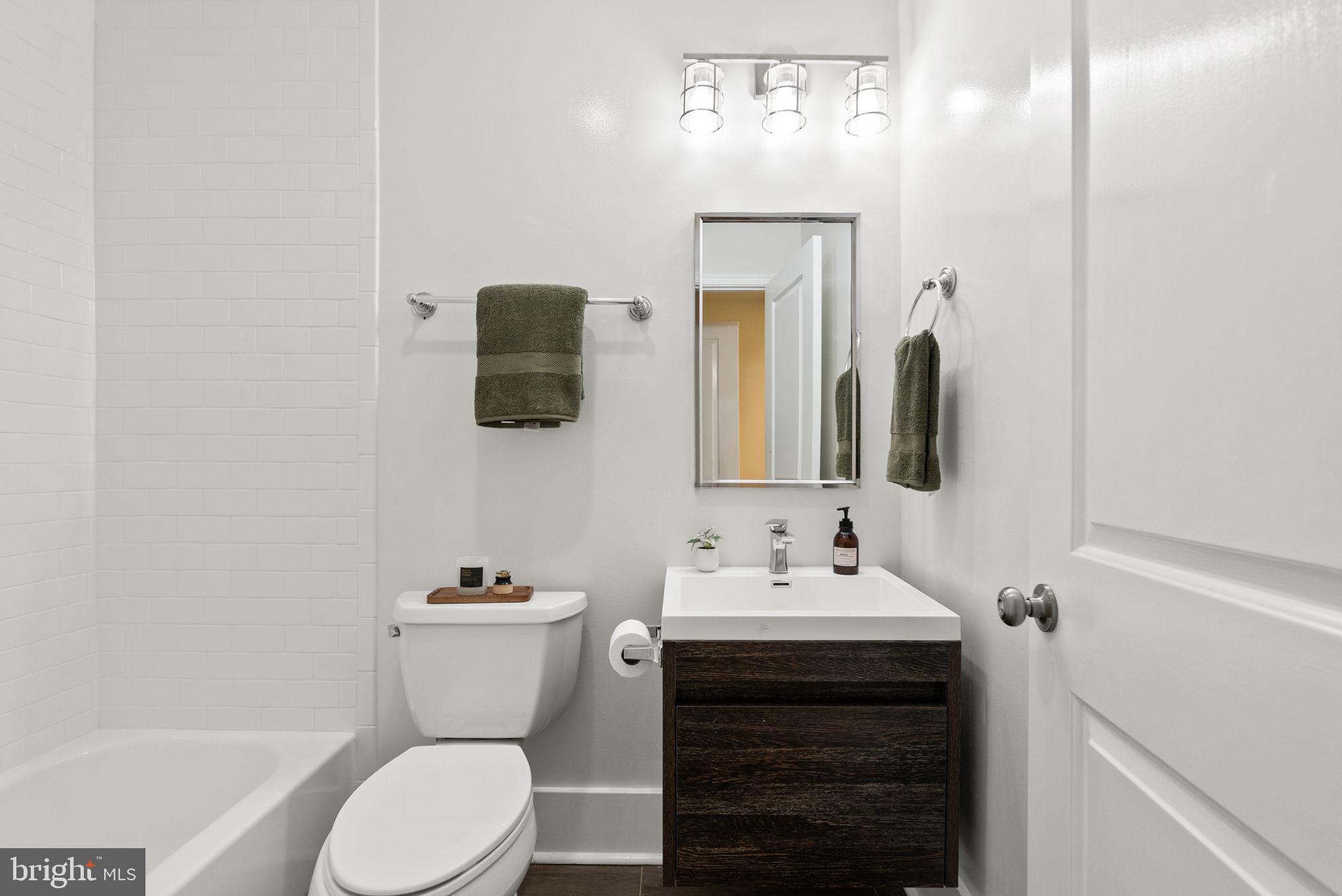 113 Hamilton Street Northwest Washington, DC 20011 - Photo 15 of 24 a bathroom with a sink vanity mirror and toilet