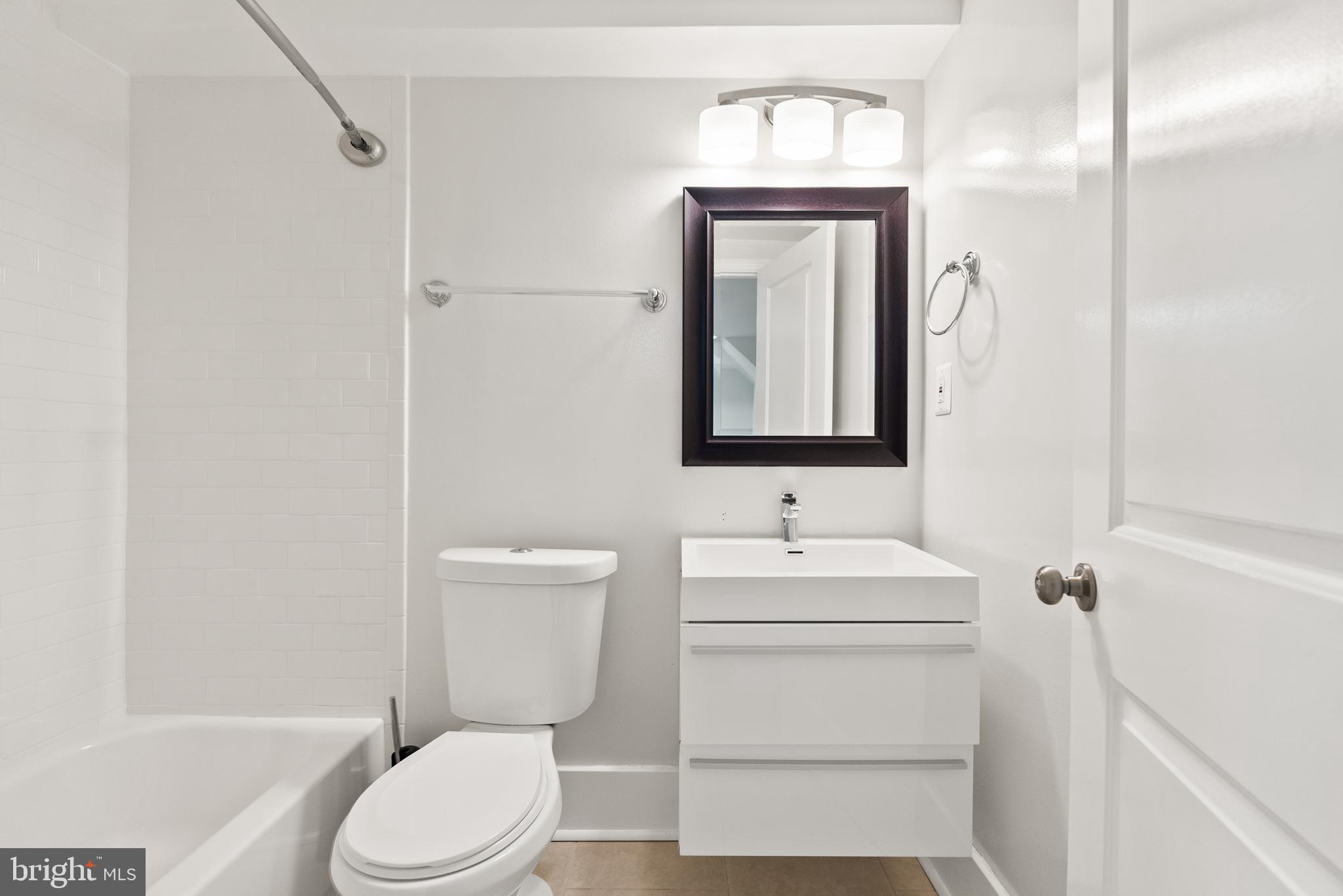 113 Hamilton Street Northwest Washington, DC 20011 - Photo 21 of 24 a bathroom with a toilet sink vanity and mirror